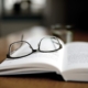 book with glasses on top