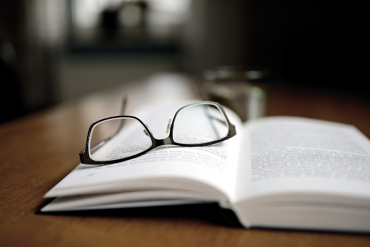 book with glasses on top